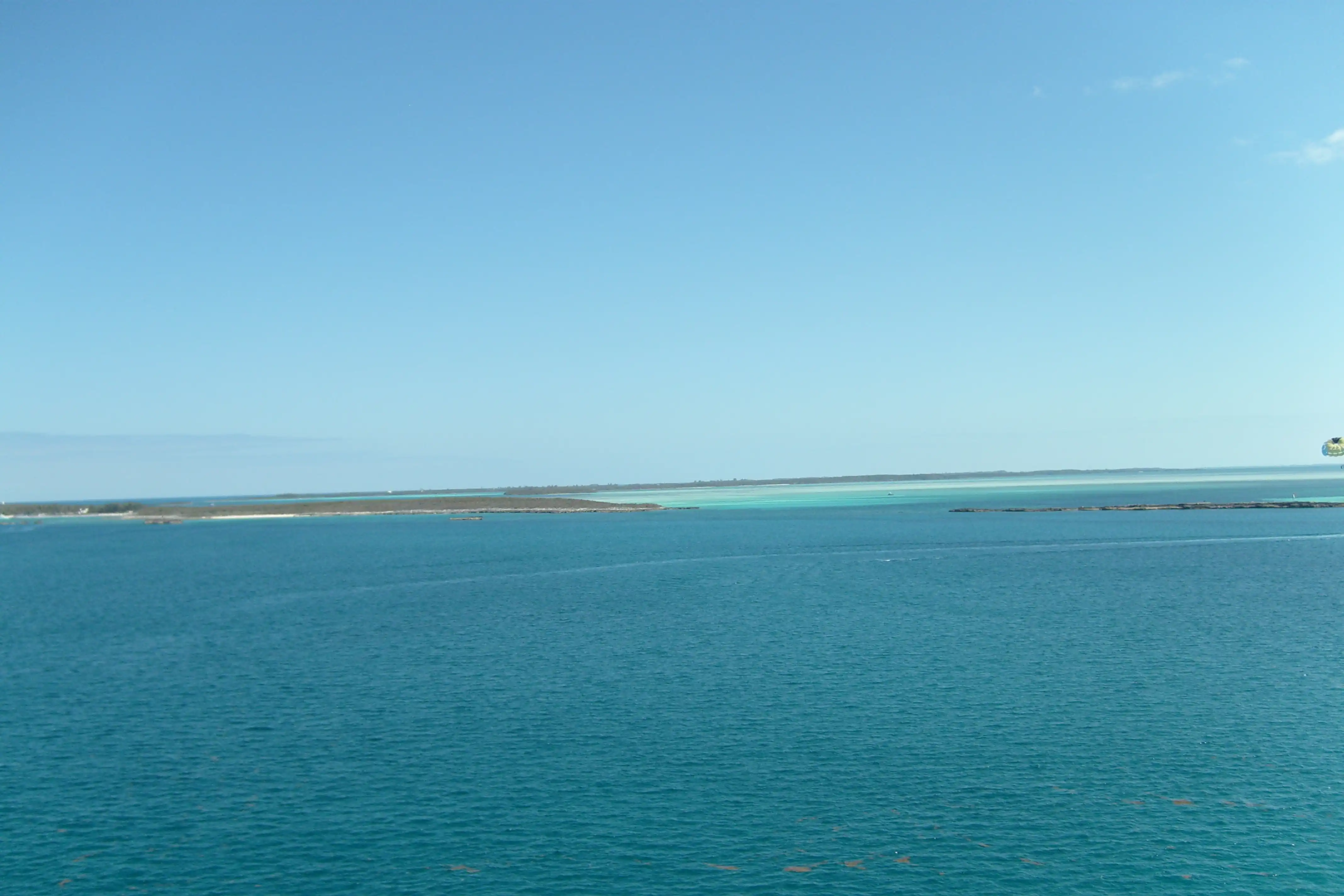 A large island chain in the tropics shot from aboard a cruise ship deck