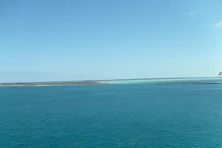 A large island chain in the tropics shot from aboard a cruise ship deck