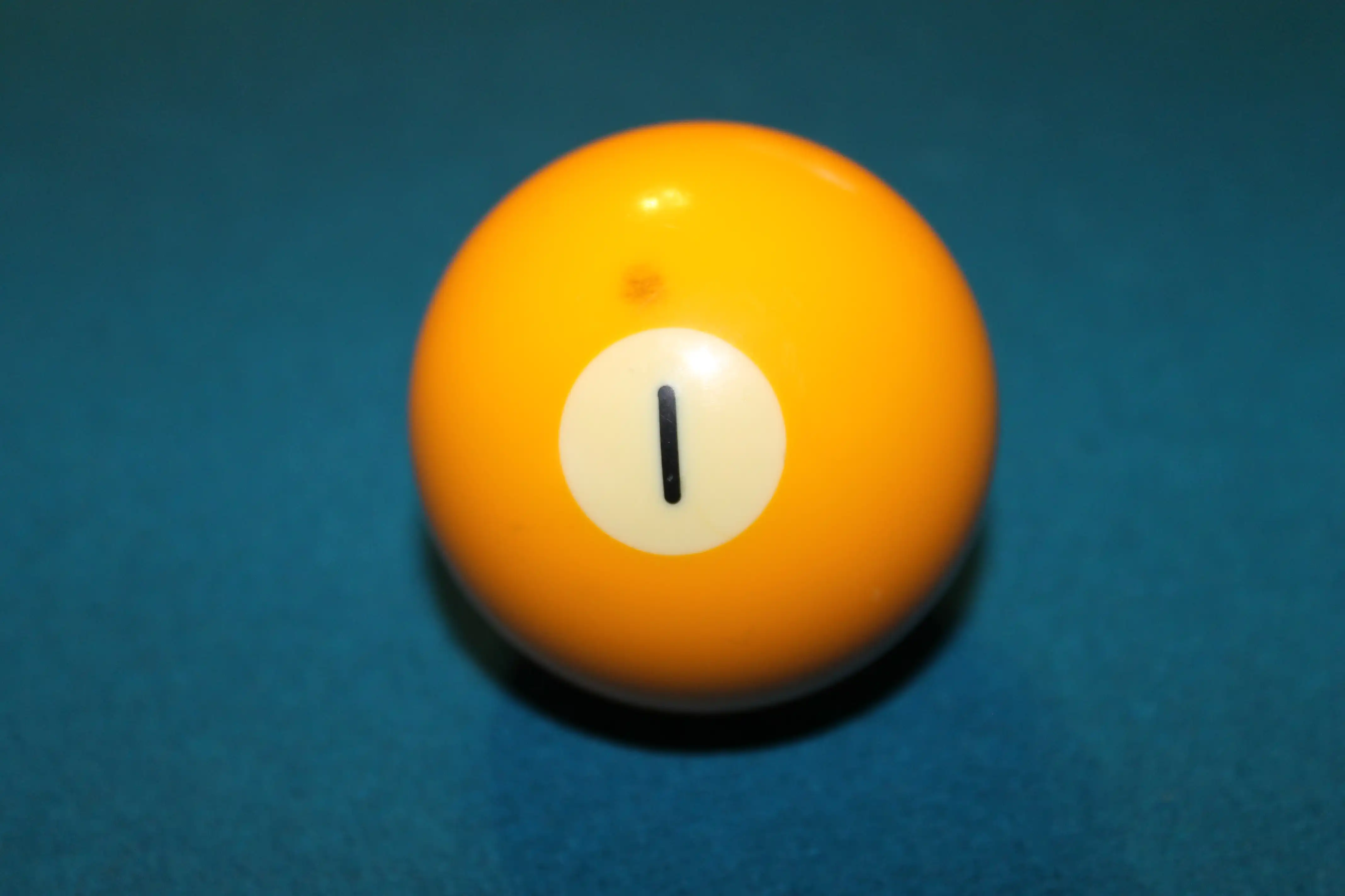 Yellow number one billiard ball