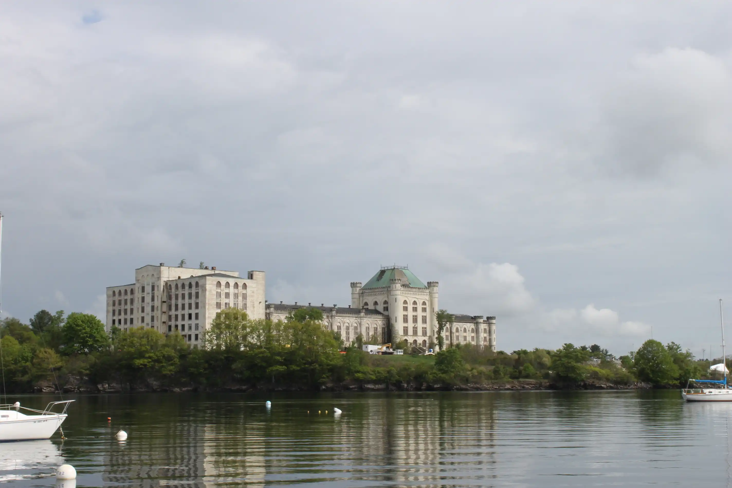 An old building on an island shot from a boat in the surrounding waters